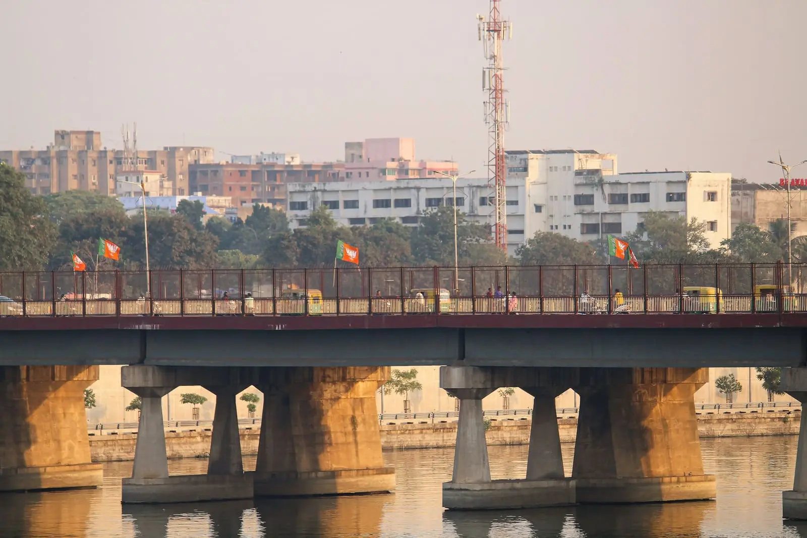 A bridge over the Sabarmati river in Ahmedabad with flags along its railing