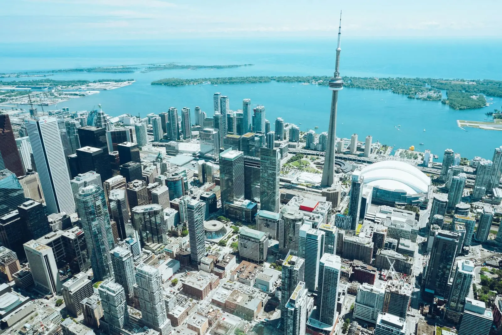 Aerial view of a financial district's towers beside the waterfront